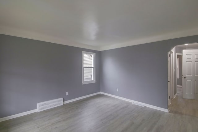 unfurnished room with light wood-type flooring