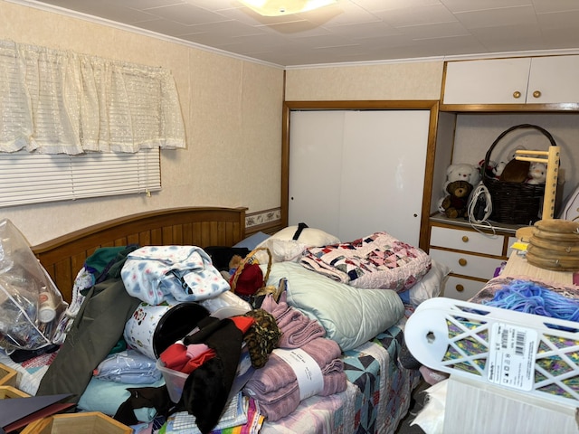 bedroom with a closet and ornamental molding