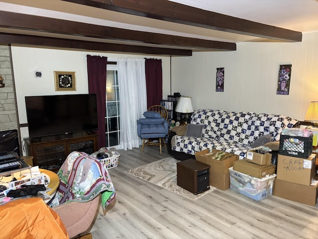 living room featuring light hardwood / wood-style flooring and beamed ceiling