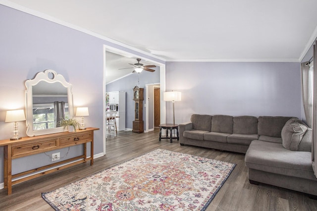 living room with crown molding, vaulted ceiling, ceiling fan, and dark hardwood / wood-style flooring