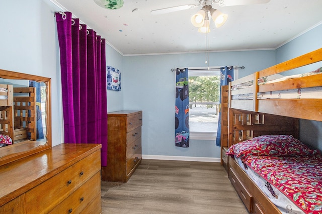 bedroom featuring light wood-type flooring, ceiling fan, and ornamental molding