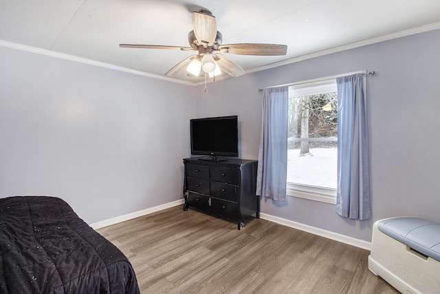 bedroom with ceiling fan, wood-type flooring, and ornamental molding