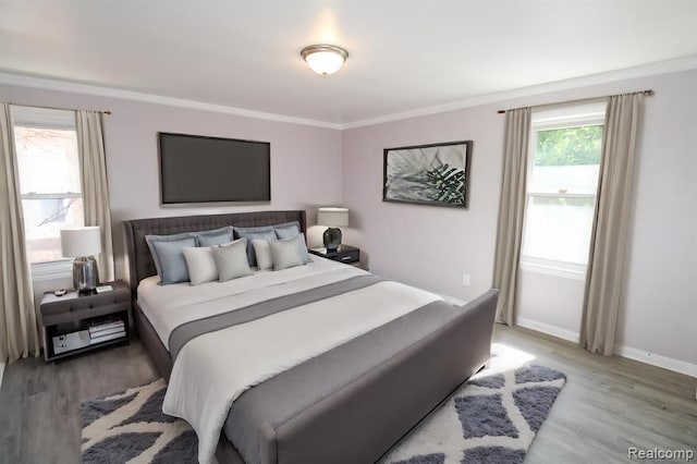 bedroom featuring hardwood / wood-style flooring and ornamental molding