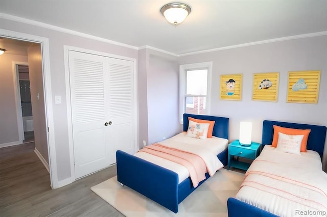 bedroom with wood-type flooring, a closet, and ornamental molding