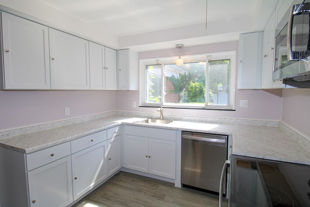 kitchen featuring sink, white cabinetry, dark hardwood / wood-style floors, and stainless steel appliances