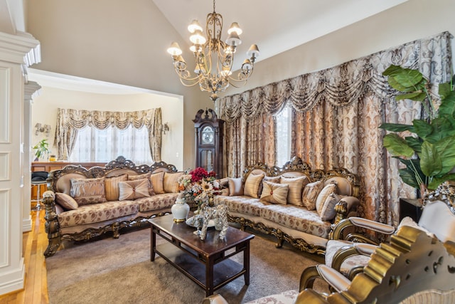 living room with a chandelier and high vaulted ceiling