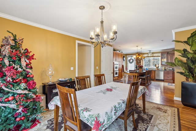 dining area with an inviting chandelier, hardwood / wood-style flooring, and ornamental molding