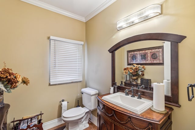 bathroom featuring toilet, vanity, and ornamental molding