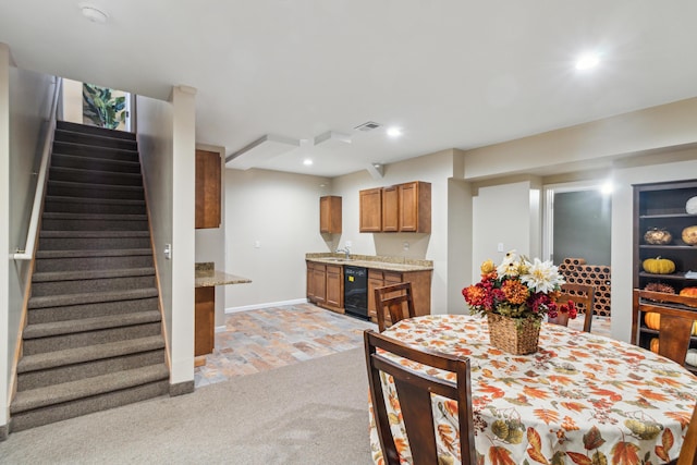 dining space featuring sink, light colored carpet, and wine cooler