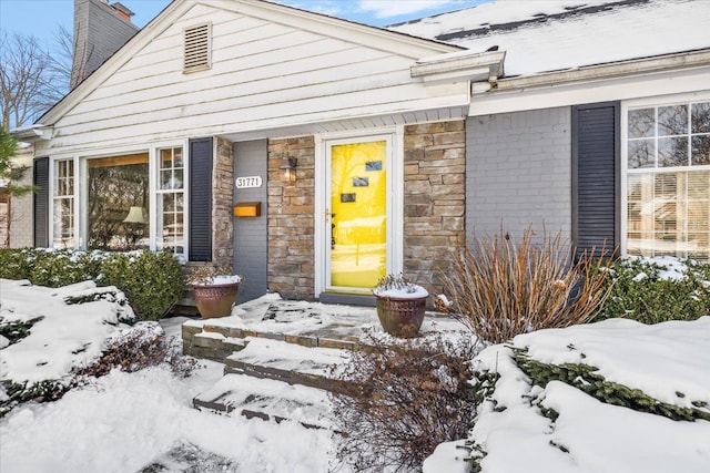 view of snow covered property entrance