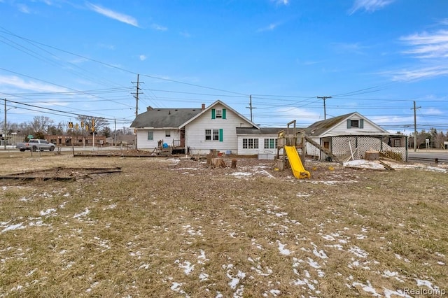 back of house featuring a playground