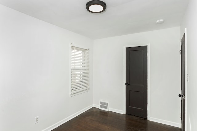 spare room featuring dark hardwood / wood-style flooring