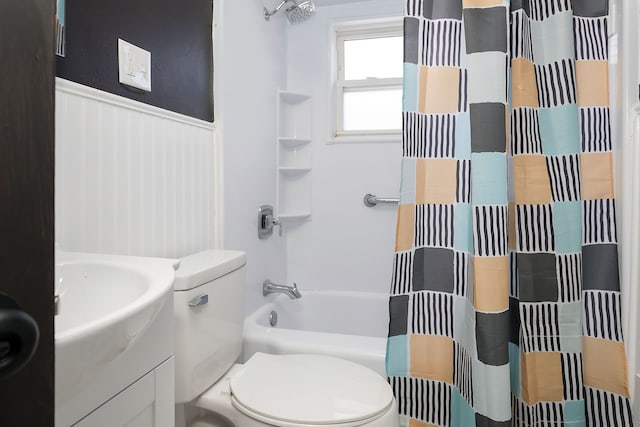 full bathroom with toilet, vanity, and shower / tub combo with curtain