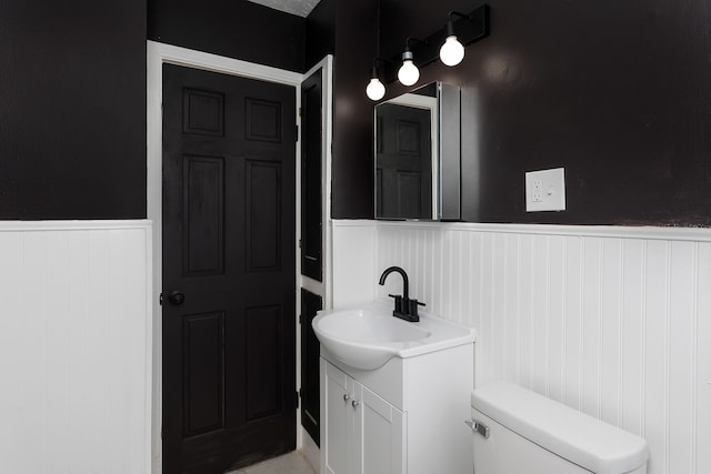 bathroom featuring toilet and vanity