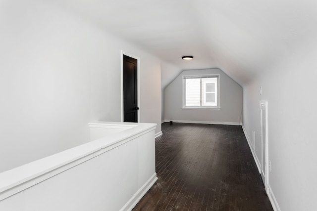 additional living space featuring dark hardwood / wood-style flooring and lofted ceiling