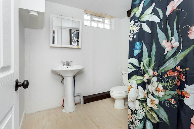 bathroom featuring sink, hardwood / wood-style flooring, and toilet