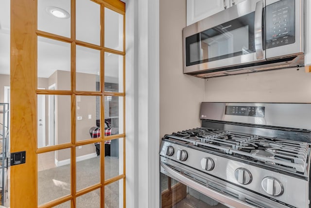 kitchen with white cabinetry and stainless steel appliances