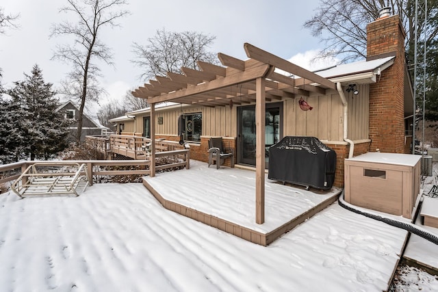 snow covered deck with a grill and a pergola