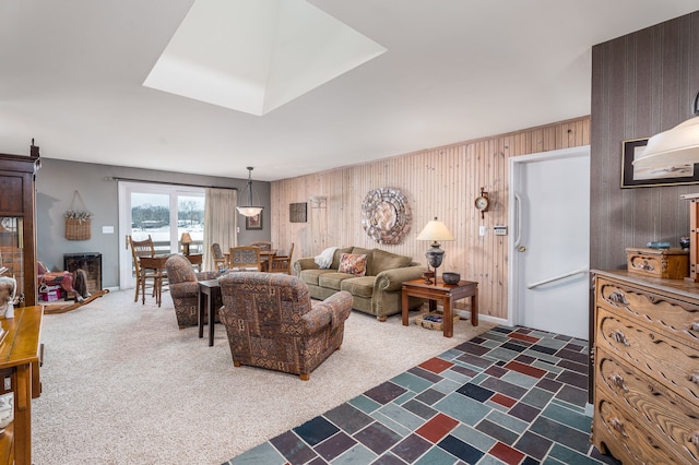 living room with dark colored carpet and wooden walls