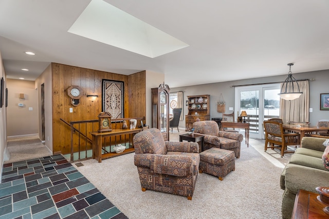 living room featuring carpet floors and wood walls