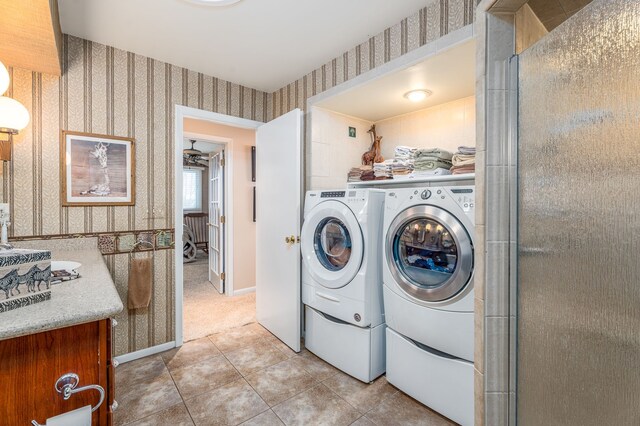 laundry room featuring washer and dryer and light tile patterned floors