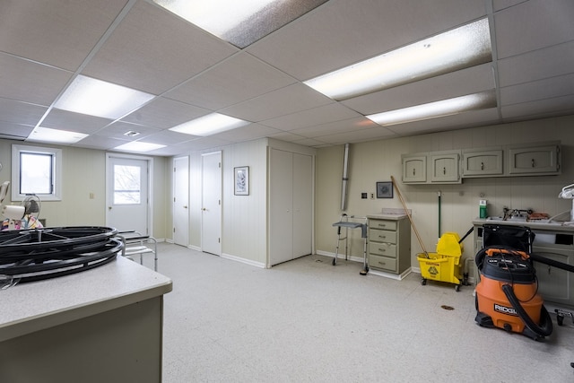 interior space with a paneled ceiling