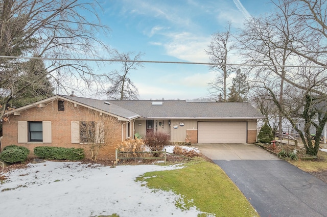 single story home featuring driveway, a garage, and brick siding