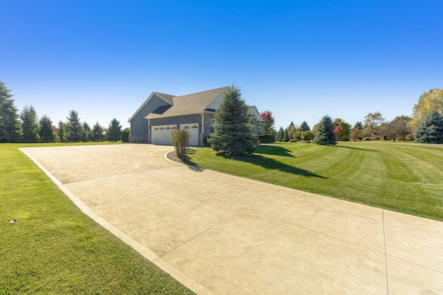 view of side of property with concrete driveway and a lawn