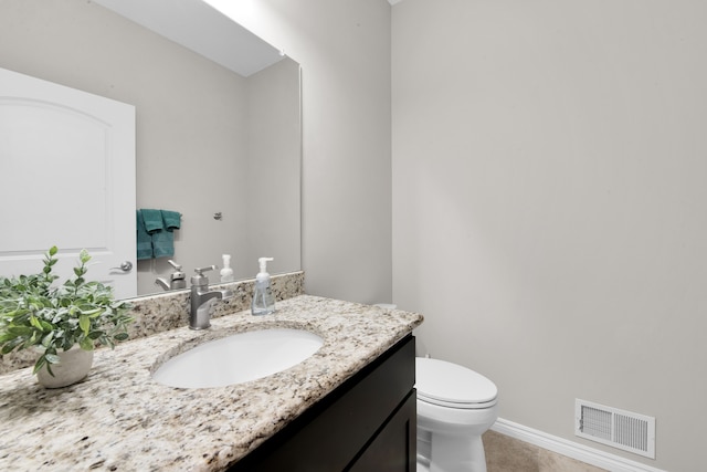 bathroom with visible vents, toilet, vanity, tile patterned flooring, and baseboards