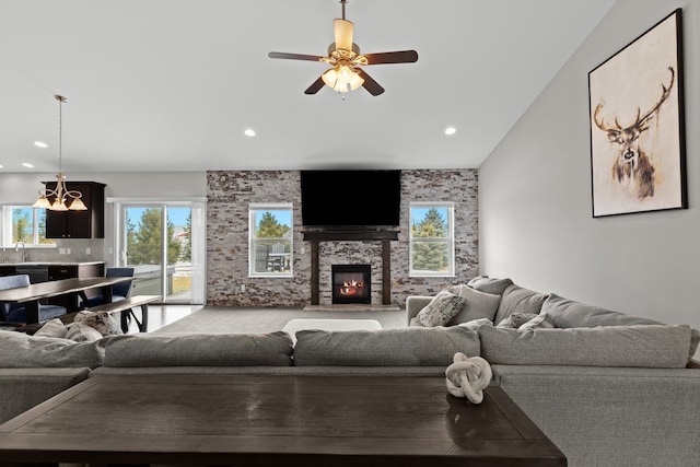 living room featuring a fireplace, a ceiling fan, and recessed lighting