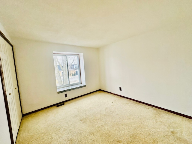 unfurnished bedroom featuring light colored carpet