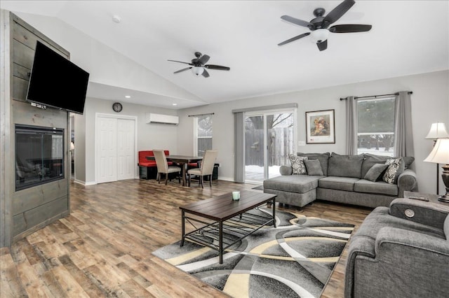 living room featuring wood-type flooring, a wall unit AC, high vaulted ceiling, and ceiling fan