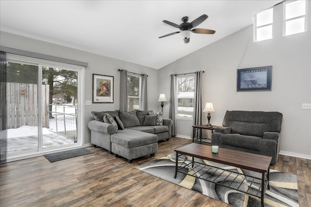 living room featuring vaulted ceiling, a healthy amount of sunlight, ceiling fan, and hardwood / wood-style flooring