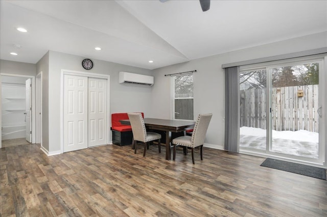 dining area with dark hardwood / wood-style flooring, lofted ceiling, and a wall mounted AC