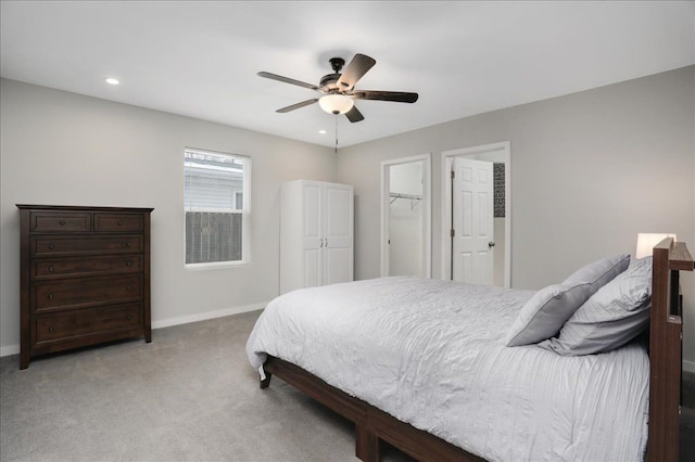 bedroom featuring a closet, ceiling fan, a spacious closet, and carpet floors