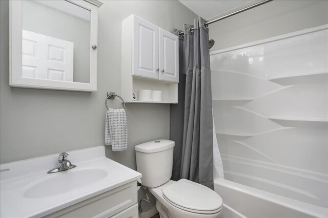 full bathroom featuring toilet, shower / bath combination with curtain, and vanity