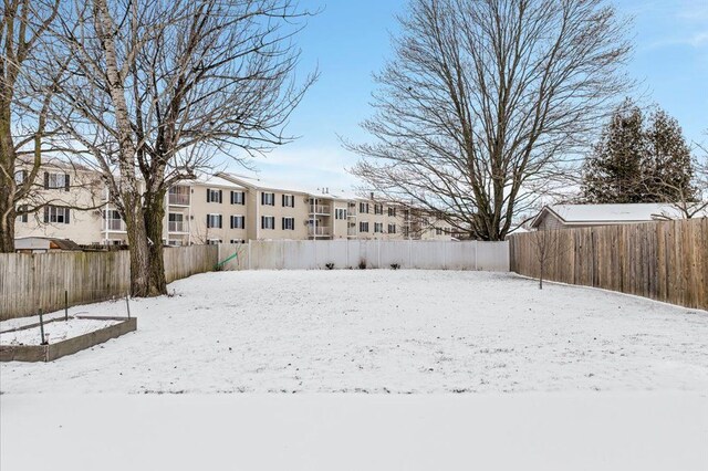 view of yard layered in snow