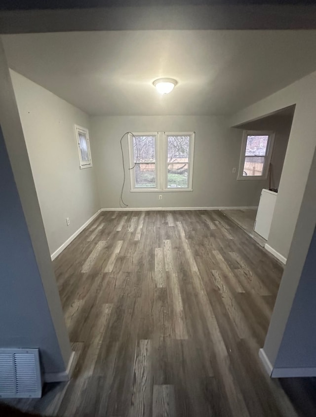 unfurnished room with dark hardwood / wood-style floors