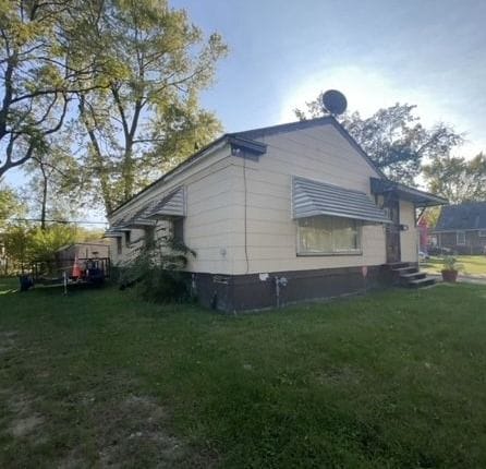 view of side of home featuring a lawn