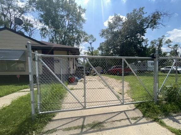 view of gate featuring a yard