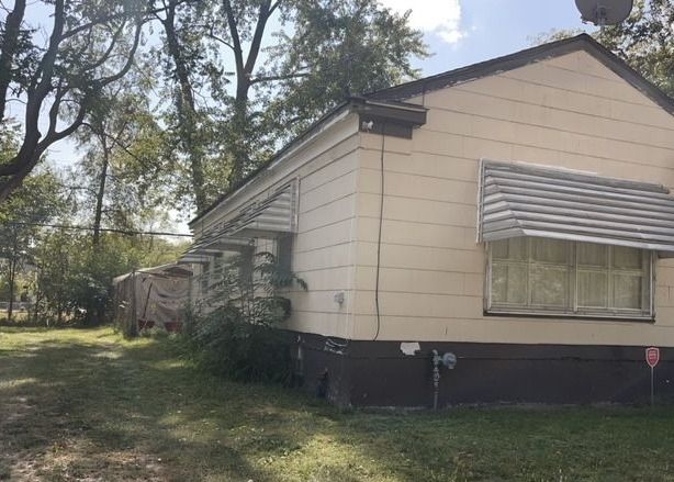 view of property exterior with a lawn