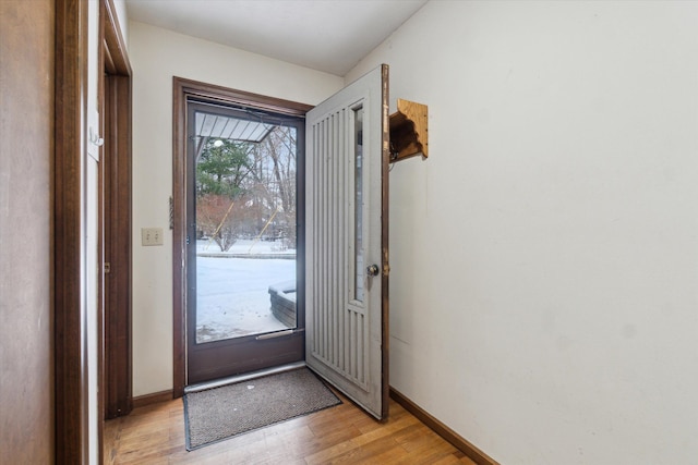 doorway to outside with light wood-type flooring