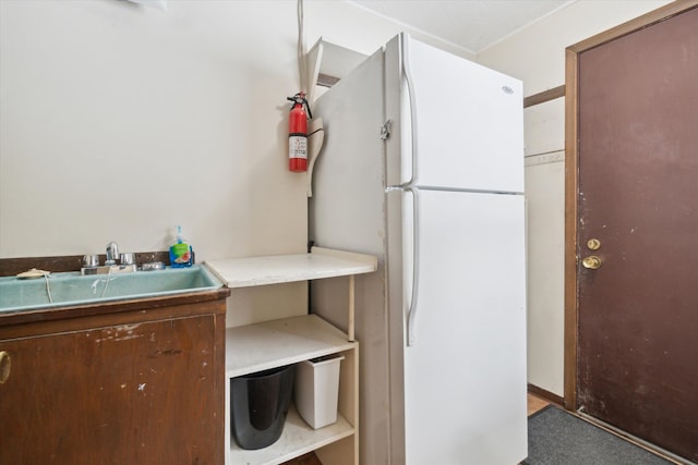 kitchen featuring sink and white refrigerator