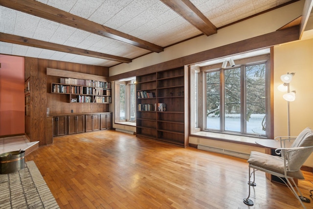 sitting room featuring beamed ceiling, light hardwood / wood-style flooring, and a baseboard radiator