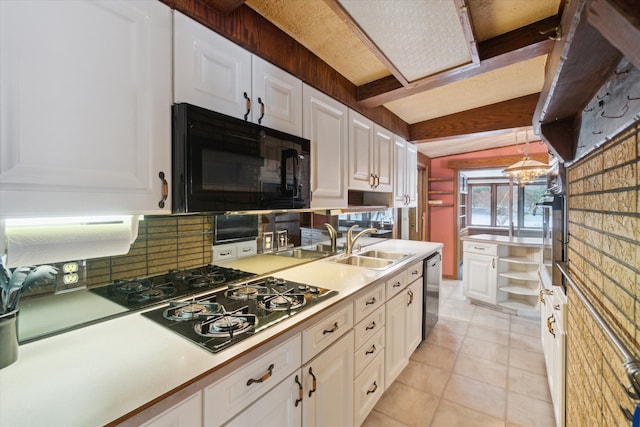 kitchen with black appliances, white cabinetry, light tile patterned floors, and pendant lighting