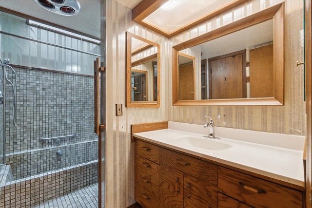 bathroom featuring vanity and a tile shower