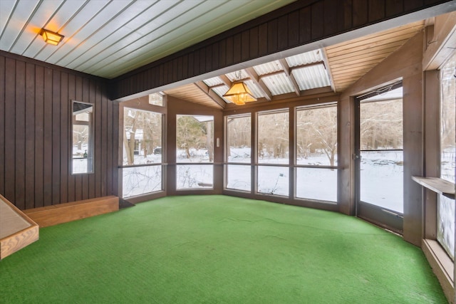 unfurnished sunroom with vaulted ceiling and a healthy amount of sunlight