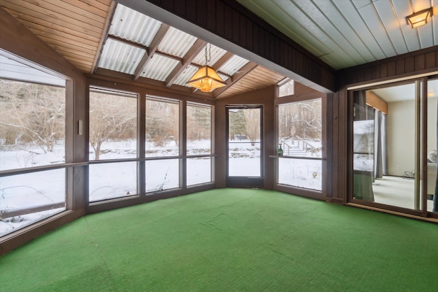 unfurnished sunroom featuring vaulted ceiling and a wealth of natural light