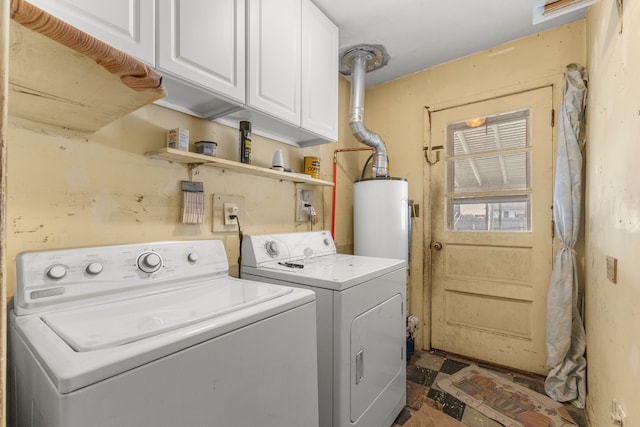 laundry area with washing machine and dryer, cabinets, and water heater