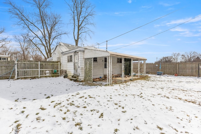 view of snow covered rear of property